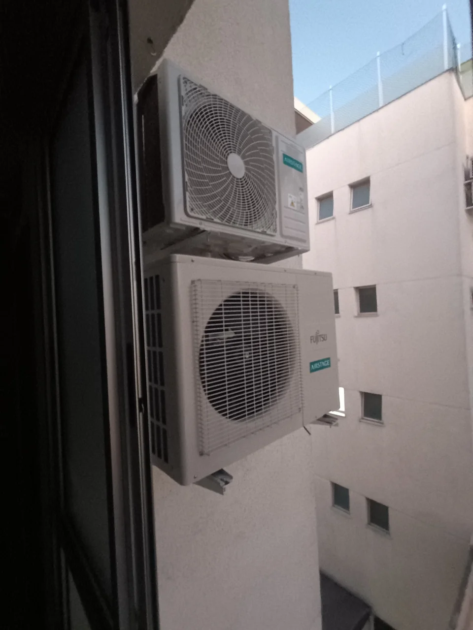Duas unidades externas de ar-condicionado em suportes na fachada